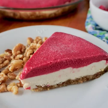 raspberry cheesecake on a plate with walnuts