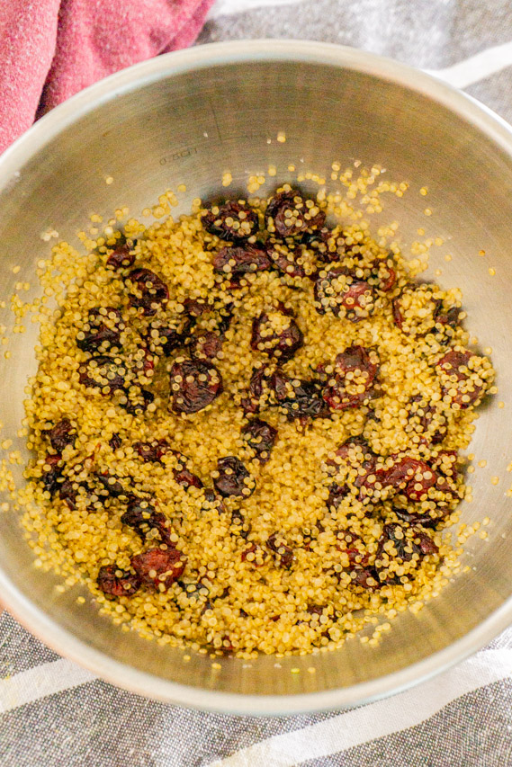 Add the toasted quinoa to a bowl and mix the salt and cranberries in.