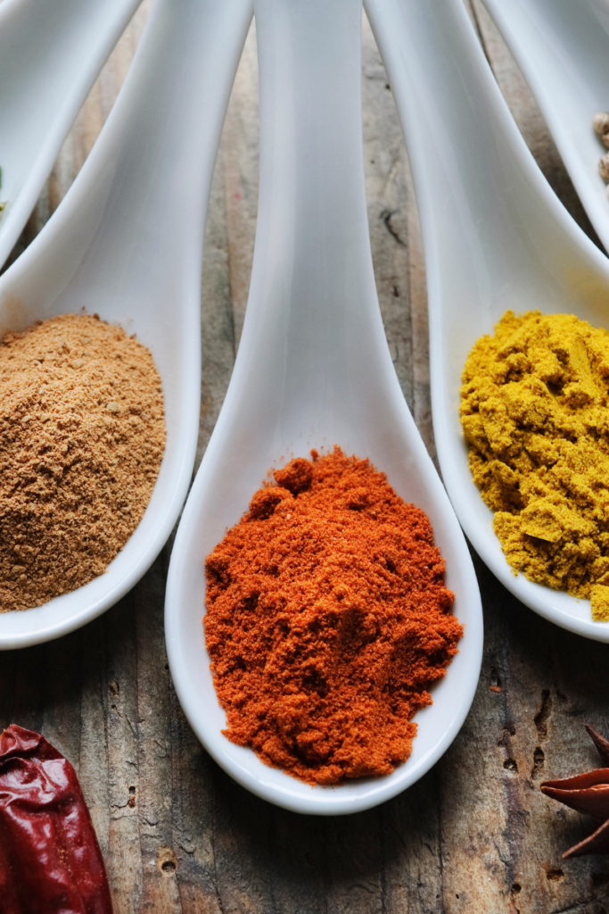 different types of curry powder on spoons